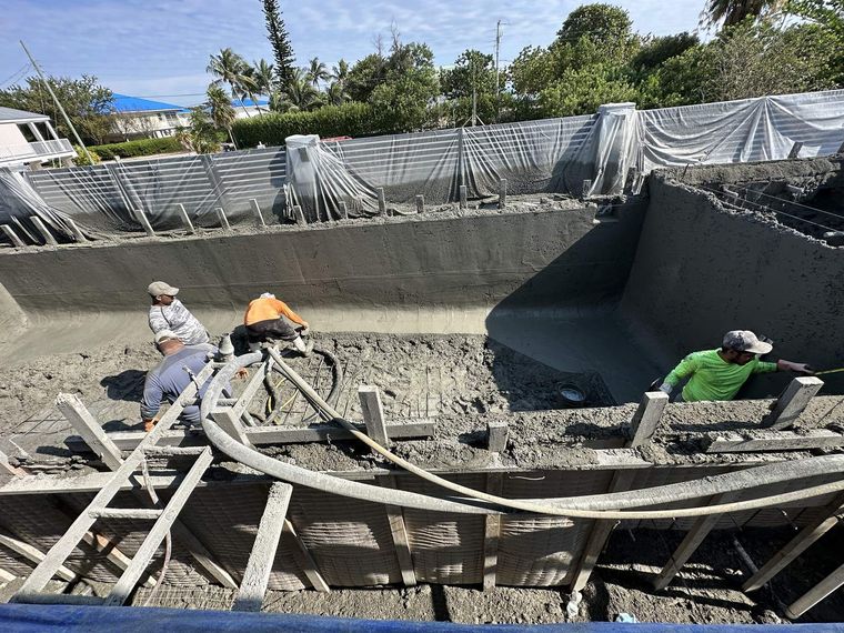 Crew pouring a pool shell